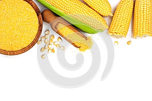 Corn groats or cornmeal in wooden bowl and corncob isolated on white background. Top view. Flat lay