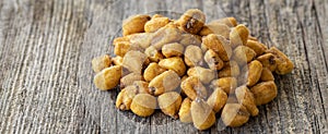Corn nuts with sauce on wood background.