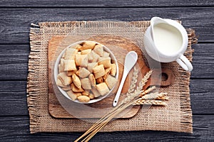 Corn pads with milk in jar and wheat ears