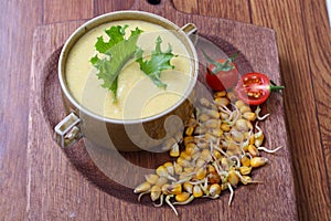 Corn porridge with vegetables on a wooden table