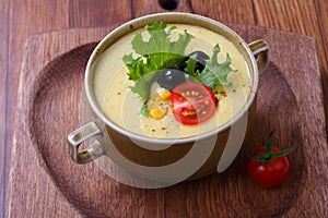 Corn porridge with vegetables on a wooden table