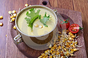 Corn porridge with vegetables on a wooden table