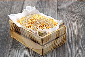 Corn seeds for popcorn isolated on dark rustic background. Copy space