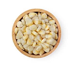 Corn seeds in wood bowl   on white background. top view