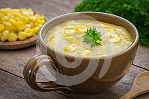 Corn soup in bowl and sweet corn on plate