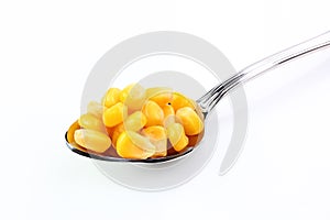 Corn in spoon on table photo