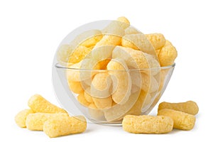 Corn sticks in a glass plate and scattered on a white, isolated.