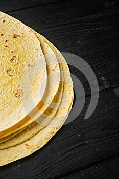 Corn Tortilla, on black wooden table background  with copy space for text