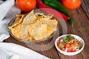 Corn tortilla chips with tomato salsa.