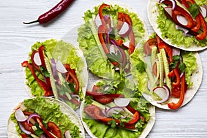 Corn tortillas with lettuce, redish, cucumber, onion, parsley an