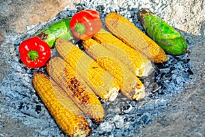 Corn and vegetables cooked on embers
