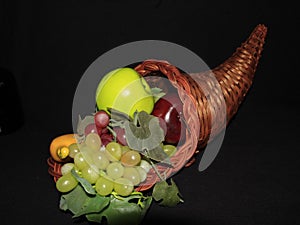 cornacopia with assorted fruits. wicker basket horn shaped
