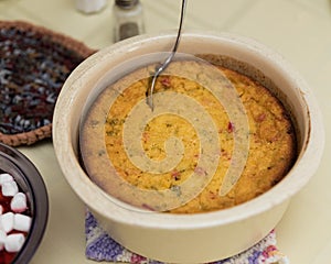 a cornbread casserole on the holiday dining room table
