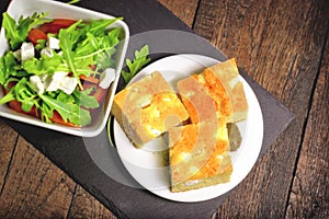 Cornbread and salad, healthy meal on plate on rustic table