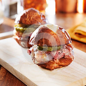 Corned beef and cheese sliders on pretzel bun