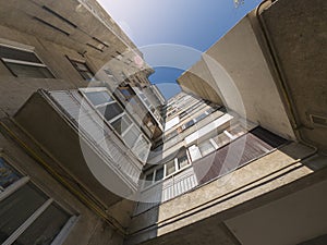 Corner of an apartment building, balconies, view upwards