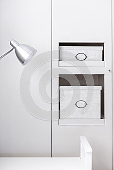 Corner of a bedroom with alcoves for decorative storage boxes