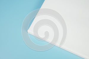 Corner of blank canvas on blue background.