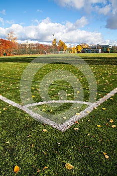 Corner border of football field with autumn leaves