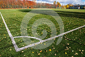 Corner border of football field with autumn leaves