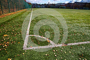 Corner border of football field with autumn leaves