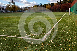 Corner border of football field with autumn leaves