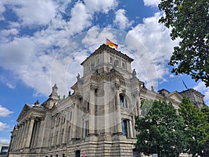 The corner of the German Bundestag with large German flag on the top of the tower