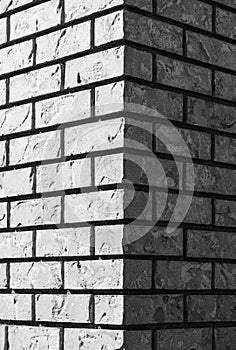 Corner of gray brick wall. Gray brickGray brick and brick edge from pillar in front of wall as texture background