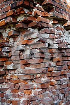 Corner of a half-ruined red brickwork, close up of an building