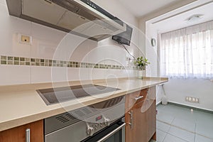 Corner of a kitchen with cherry wood cabinets