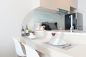 Corner kitchen with dining table in modern condominium