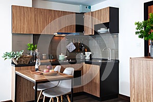 Corner kitchen with dining table in room condominium.