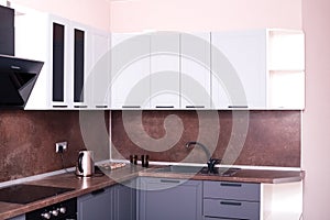 Corner kitchen interior with dark brown countertop and backsplash. home furnishings