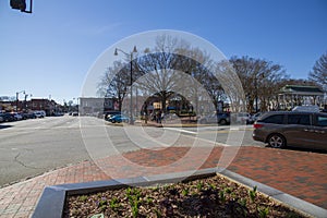 The corner of North Park street at the Marietta Square surrounded by bare winter trees, people and parked cars