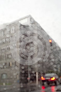 A corner of an office building at rainy day shot through a car window