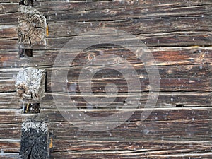 Corner old cabin wall with falling snow background