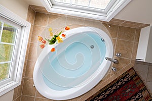 Corner oval bathtub full of clean water