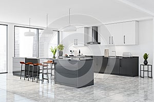 Corner of panoramic white, grey kitchen with orange bar stools