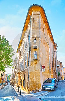 The sharp house corner with wall sculpture of Our Lady Oratoire Vierge a l`Enfant, Aix-en-Provence, France photo