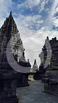 corner of Prambanan temple under a cloudy sky