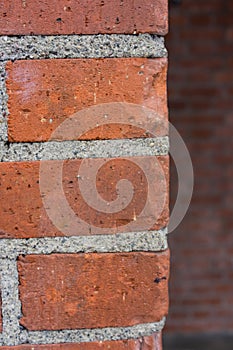 Corner of red brick wall close up