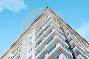 Corner of a residential apartment building against the blue sky