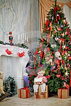 Corner of room with big Christmas tree, fireplace,
