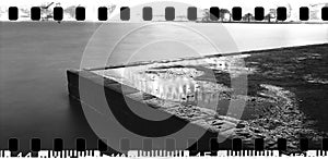 Corner stone pier Sydney Harbour NSW Australia night wide panorama monochrome city lights reflecting on water on surface sprockets