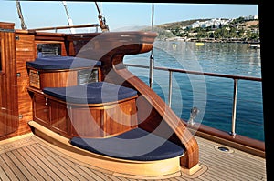 A corner with three step seat on the deck of the wooden classical luxury gulet.