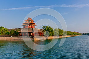 Corner tower and moat of Forbidden City under blue sky, in Beijing, China