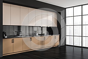 Corner view of beige and black kitchen cabinet