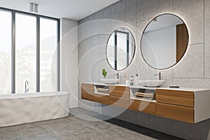 Corner view on bright bathroom interior with bathtub, panoramic window