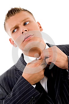 Corner view of businessman tucking his button