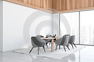 Corner view of panoramic white dining room with dark grey chairs